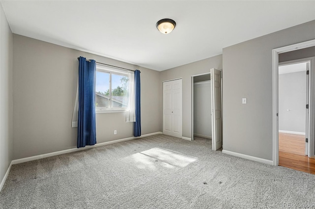 3570 E Arapahoe Pl, Centennial, CO 80122 - unfurnished bedroom featuring two closets, carpet flooring, and baseboards