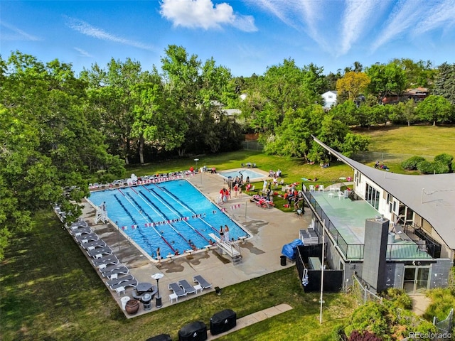 3570 E Arapahoe Pl, Centennial, CO 80122 - community pool featuring a patio area, view of wooded area, and a lawn