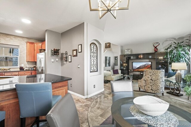 dining space featuring recessed lighting, baseboards, an inviting chandelier, and marble finish floor