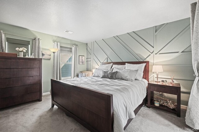carpeted bedroom with baseboards and visible vents