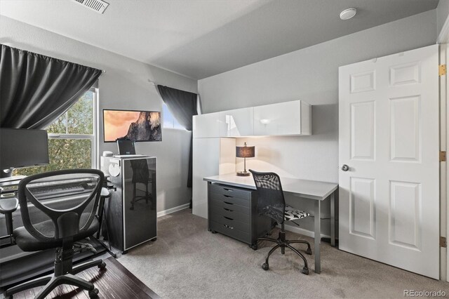 carpeted home office featuring baseboards and visible vents
