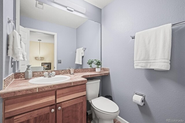bathroom featuring vanity, visible vents, and toilet