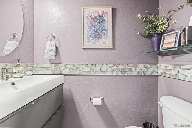 bathroom with toilet and vanity