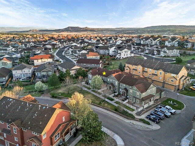 drone / aerial view featuring a residential view and a mountain view