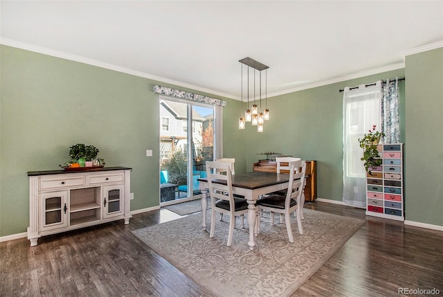 dining room with dark hardwood / wood-style flooring and ornamental molding