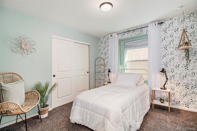 bedroom with a closet and dark carpet