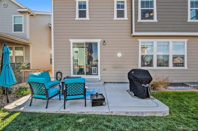 back of property with a lawn and a patio area