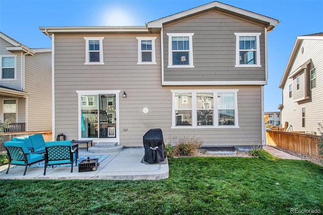 rear view of property with a yard and a patio