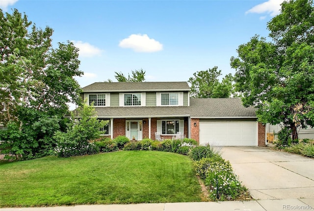 10328 W Crestone Mtn, Littleton, CO 80127 - view of front of house with brick siding, concrete driveway, an attached garage, a front yard, and roof with shingles