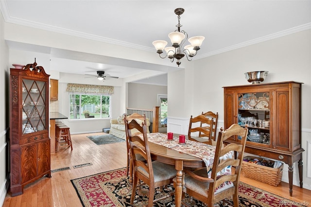 10328 W Crestone Mtn, Littleton, CO 80127 - dining space with ornamental molding, light wood-type flooring, a chandelier, and a ceiling fan