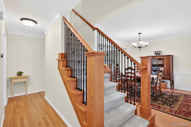 10328 W Crestone Mtn, Littleton, CO 80127 - stairs featuring a chandelier, wood finished floors, and ornamental molding