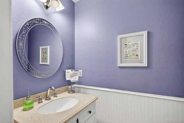 10328 W Crestone Mtn, Littleton, CO 80127 - bathroom with vanity and a wainscoted wall