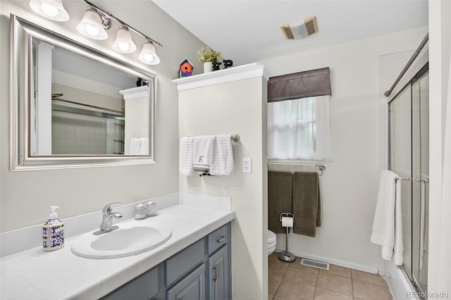 10328 W Crestone Mtn, Littleton, CO 80127 - full bathroom with vanity, an enclosed shower, and tile patterned flooring