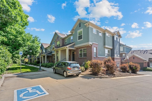 701 N Roslyn St Unit 36, Denver, CO 80230 - view of front facade with a residential view, brick siding, and stucco siding