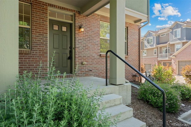 701 N Roslyn St Unit 36, Denver, CO 80230 - doorway to property featuring brick siding and a porch