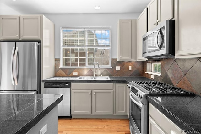 701 N Roslyn St Unit 36, Denver, CO 80230 - kitchen with appliances with stainless steel finishes, tile countertops, a sink, healthy amount of natural light, and recessed lighting