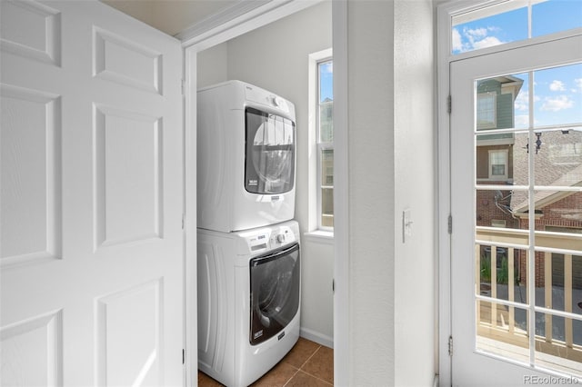 701 N Roslyn St Unit 36, Denver, CO 80230 - washroom with stacked washer / dryer and dark tile patterned flooring