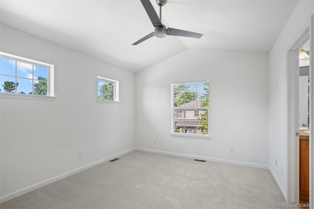 701 N Roslyn St Unit 36, Denver, CO 80230 - unfurnished room with a ceiling fan, vaulted ceiling, baseboards, and light colored carpet