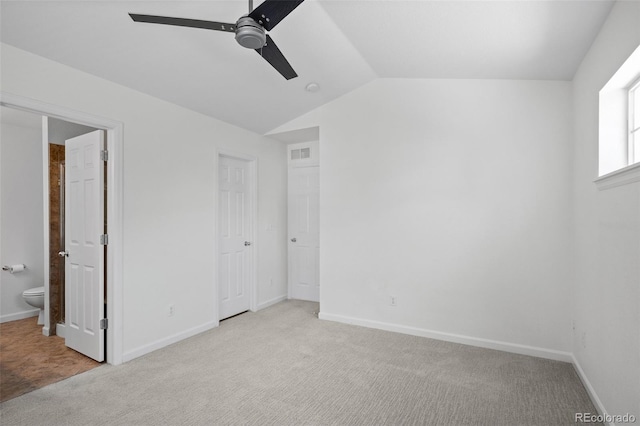 701 N Roslyn St Unit 36, Denver, CO 80230 - unfurnished bedroom with carpet, lofted ceiling, and baseboards