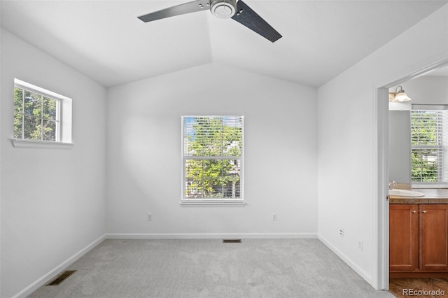 701 N Roslyn St Unit 36, Denver, CO 80230 - unfurnished room with a ceiling fan, light carpet, healthy amount of natural light, and lofted ceiling