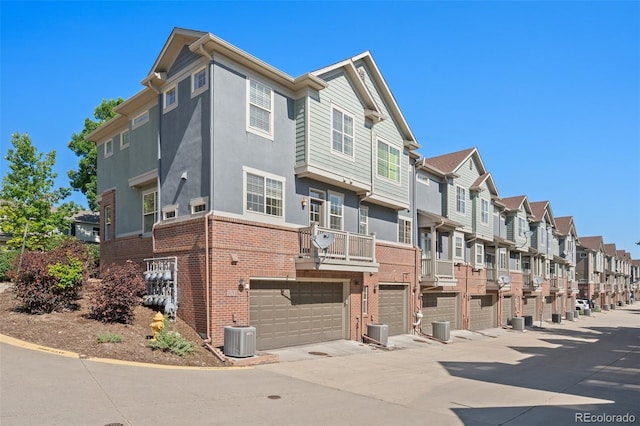 701 N Roslyn St Unit 36, Denver, CO 80230 - view of property with a residential view, central AC unit, and an attached garage