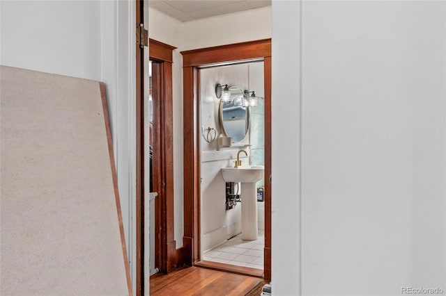 hall featuring light wood-style flooring and a sink