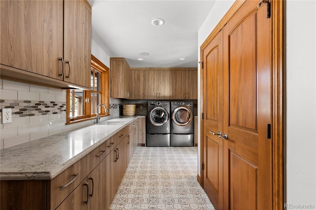 clothes washing area with sink and washing machine and dryer