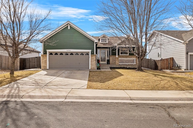 view of front of property featuring brick siding, driveway, a garage, and fence