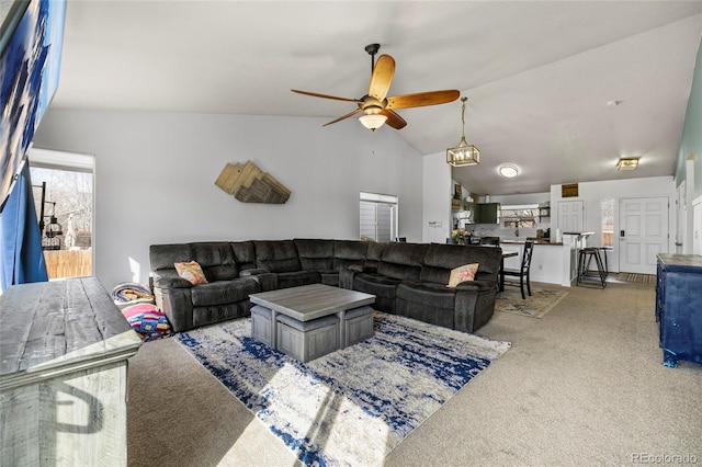 carpeted living room featuring vaulted ceiling and a ceiling fan