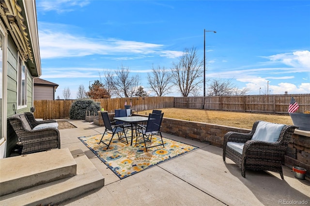 view of patio featuring a fenced backyard and outdoor dining space