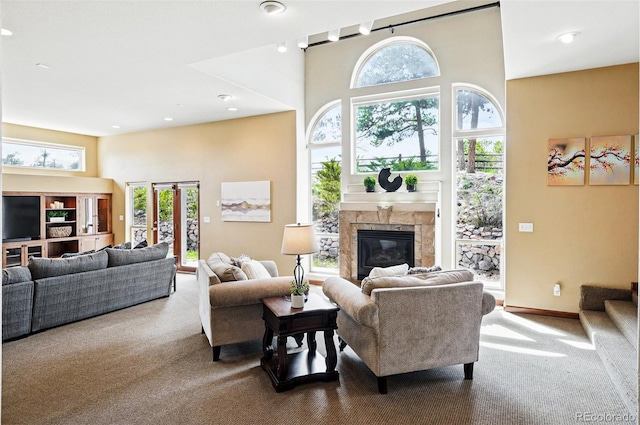 19640 Four Winds Way, Monument, CO 80132 - carpeted living area featuring a towering ceiling and a glass covered fireplace