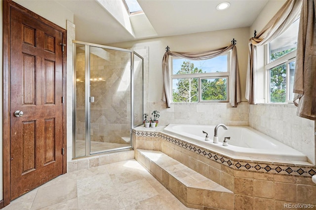 19640 Four Winds Way, Monument, CO 80132 - full bathroom with healthy amount of natural light, a bath, a skylight, a shower stall, and recessed lighting