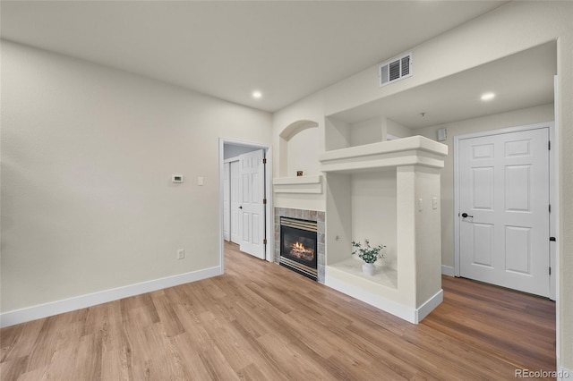9590 E Florida Ave Unit 1025, Denver, CO 80247 - unfurnished living room with a fireplace, baseboards, light wood finished floors, and recessed lighting
