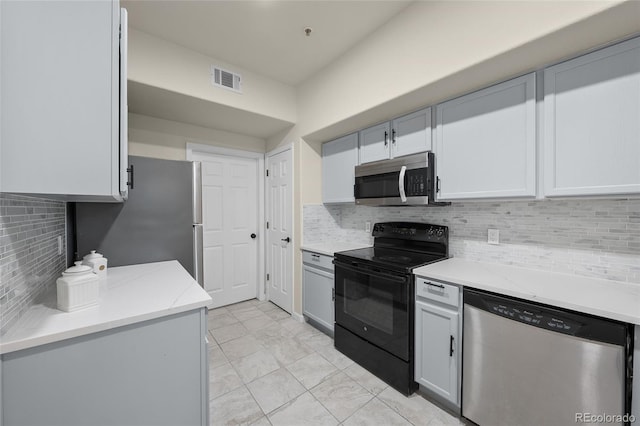 9590 E Florida Ave Unit 1025, Denver, CO 80247 - kitchen featuring appliances with stainless steel finishes, tasteful backsplash, light stone counters, and light marble finish floors