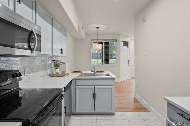 9590 E Florida Ave Unit 1025, Denver, CO 80247 - kitchen with black / electric stove, stainless steel microwave, a sink, and gray cabinetry