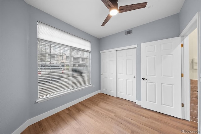 9590 E Florida Ave Unit 1025, Denver, CO 80247 - unfurnished bedroom featuring baseboards, light wood-style floors, a closet, and a ceiling fan