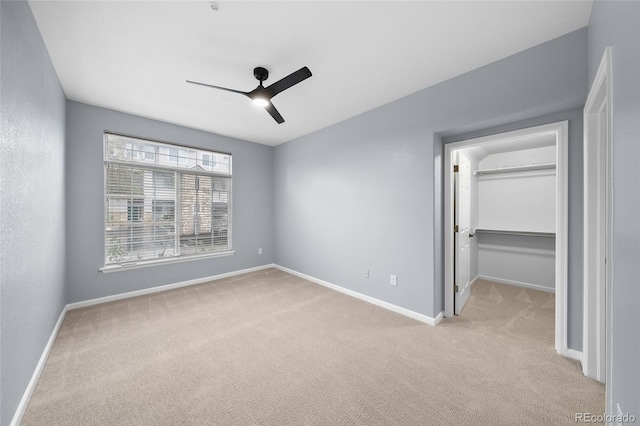 9590 E Florida Ave Unit 1025, Denver, CO 80247 - unfurnished bedroom with light carpet, a walk in closet, baseboards, a ceiling fan, and a closet