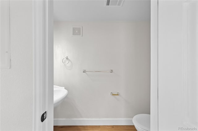 9590 E Florida Ave Unit 1025, Denver, CO 80247 - bathroom featuring baseboards and wood finished floors