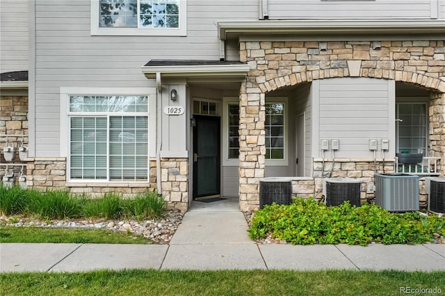 9590 E Florida Ave Unit 1025, Denver, CO 80247 - view of exterior entry with stone siding and cooling unit