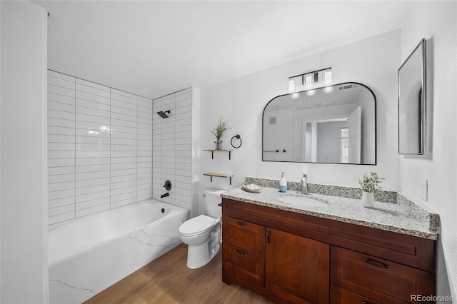 9590 E Florida Ave Unit 1025, Denver, CO 80247 - full bath featuring toilet, wood finished floors, vanity, and  shower combination