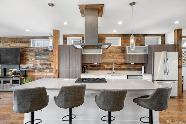 1930 W 35th Ave, Denver, CO 80211 - kitchen with appliances with stainless steel finishes, modern cabinets, a sink, island exhaust hood, and light countertops