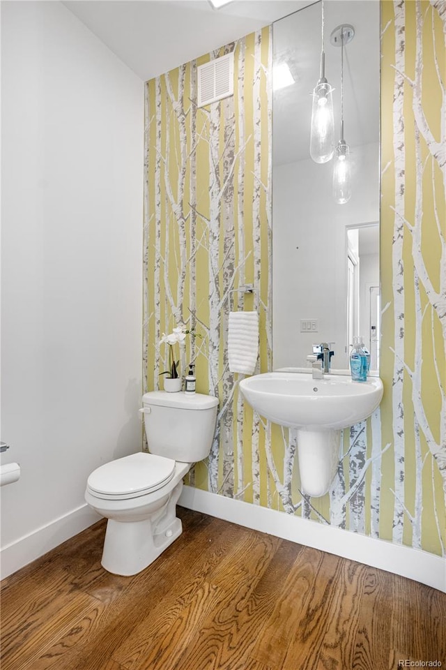 1930 W 35th Ave, Denver, CO 80211 - bathroom featuring wood finished floors, toilet, and baseboards
