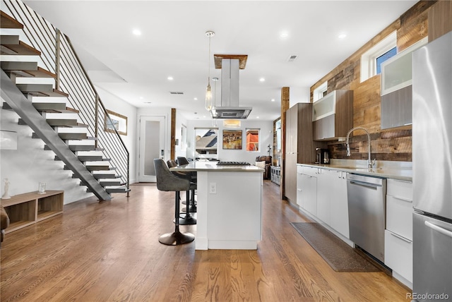 1930 W 35th Ave, Denver, CO 80211 - kitchen featuring stainless steel appliances, modern cabinets, a breakfast bar area, a kitchen island, and white cabinets