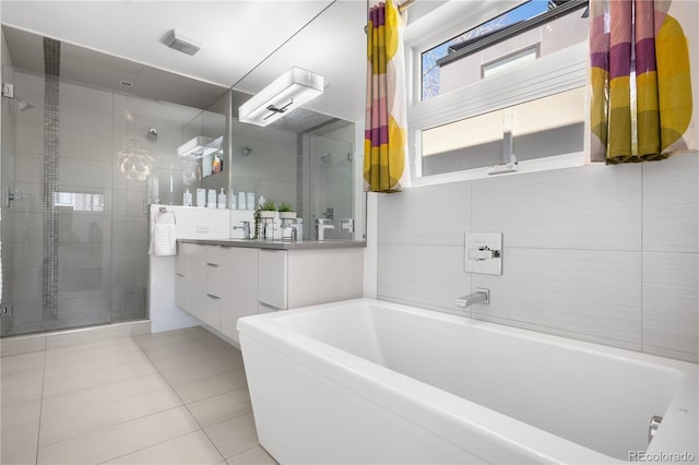 1930 W 35th Ave, Denver, CO 80211 - bathroom with a stall shower, tile patterned floors, vanity, and a bath