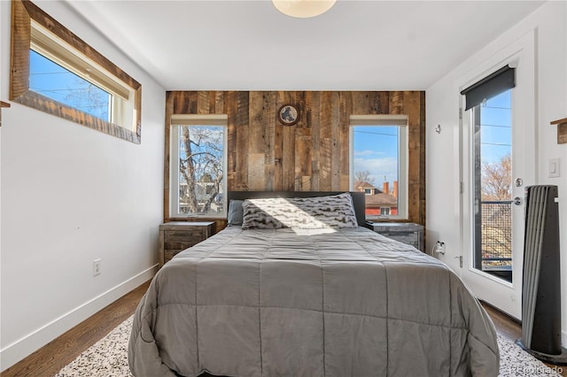 1930 W 35th Ave, Denver, CO 80211 - bedroom with baseboards, access to exterior, and dark wood-style floors