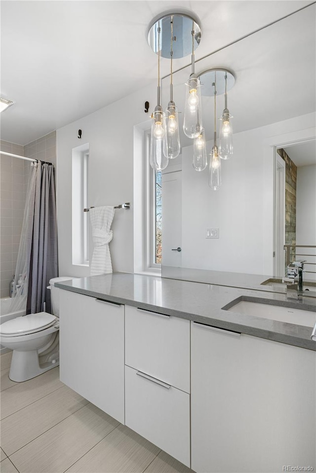 1930 W 35th Ave, Denver, CO 80211 - full bathroom featuring toilet, vanity, and shower / tub combo with curtain