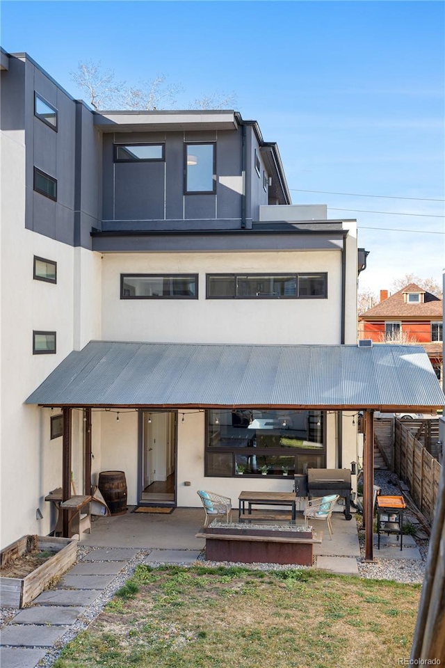 1930 W 35th Ave, Denver, CO 80211 - rear view of property featuring a patio area, stucco siding, and metal roof