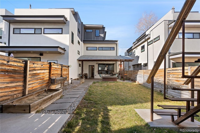 1930 W 35th Ave, Denver, CO 80211 - rear view of property featuring stucco siding, a patio area, and an outdoor hangout area