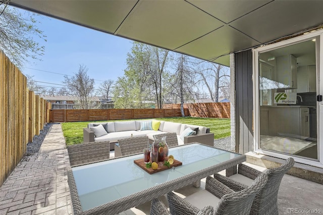 view of patio / terrace featuring an outdoor living space and a fenced backyard