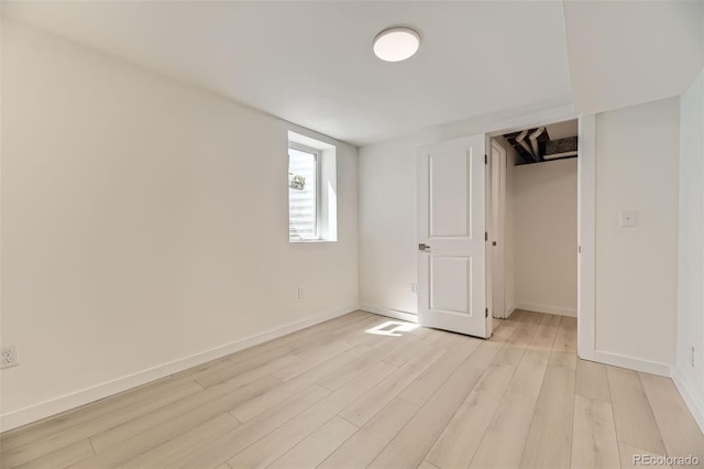 unfurnished bedroom featuring light wood-style floors and baseboards